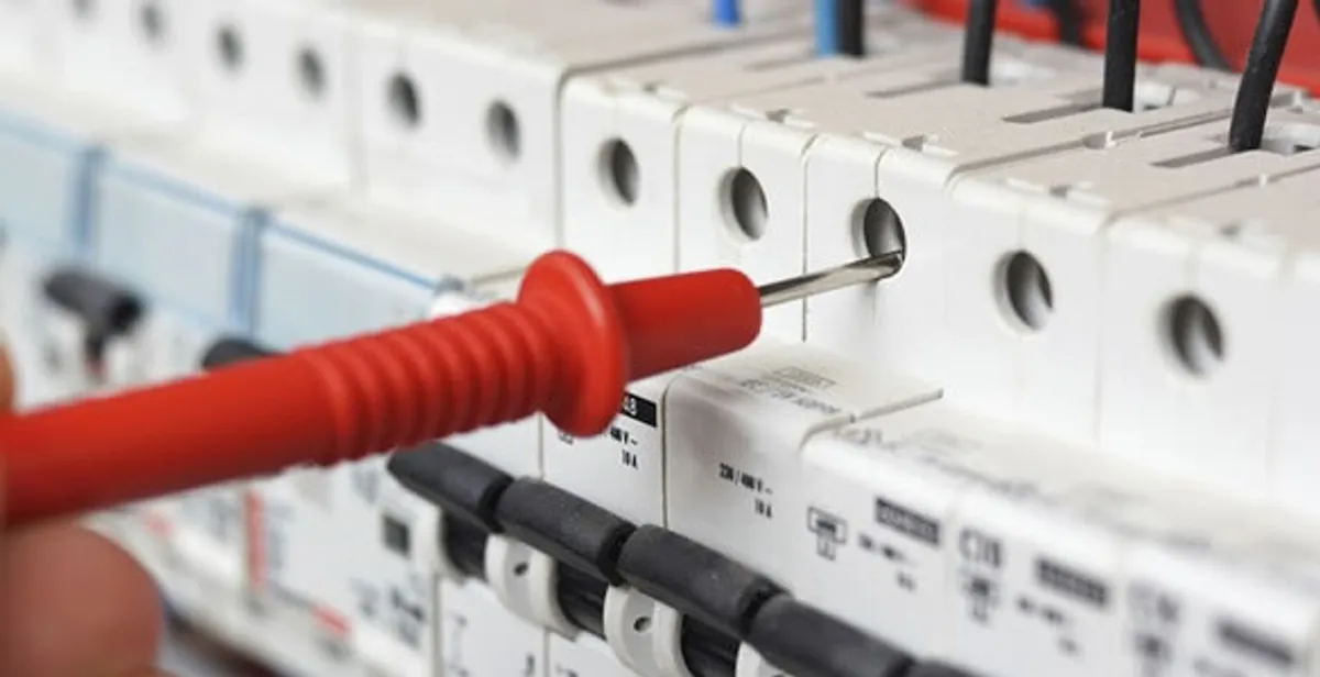 Electrical contractor testing circuit breakers during electrical repair in Butler, WI