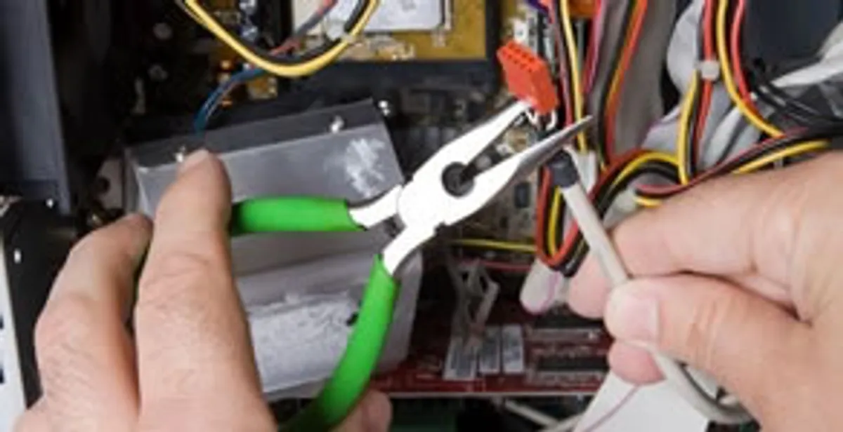 Licensed electrical contractor performing electrical repair with tools in Saint Francis, WI