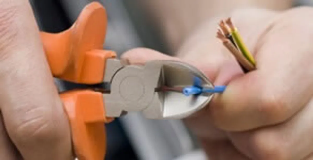 professional electrical services showing precise wire cutting by licensed electricians in Milwaukee, WI