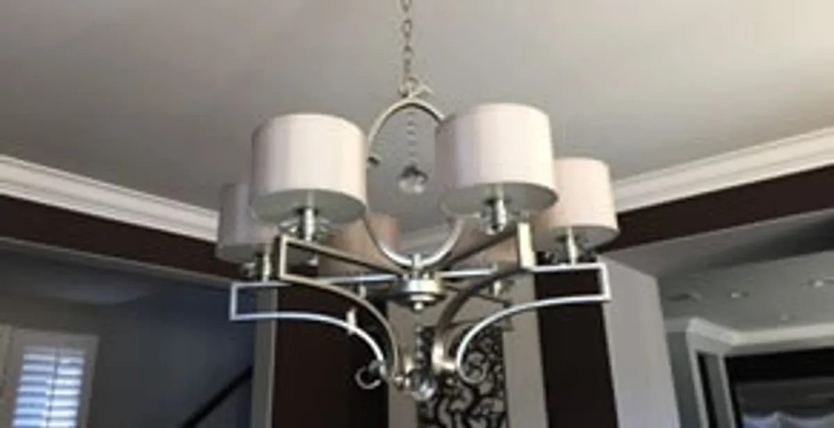 Modern chandelier installation with multiple light fixtures in Milwaukee, WI